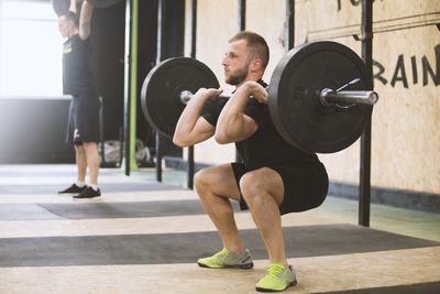 Man squatting weights