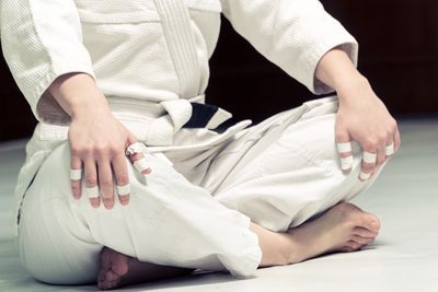 Karate person with crossed legs